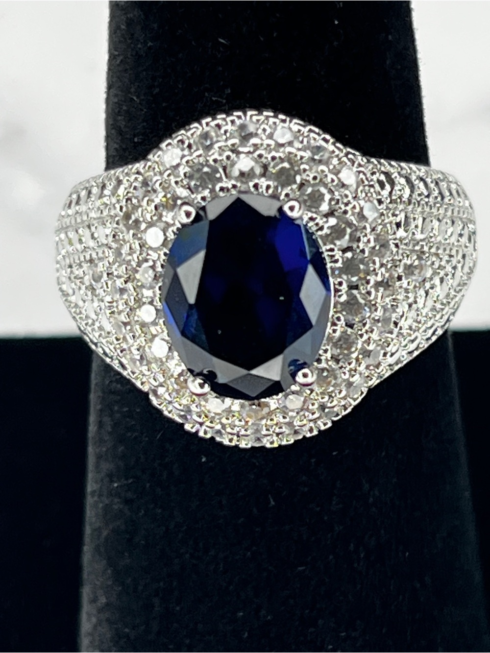 Elegant Silver Ring with Deep Blue Oval Center Stone